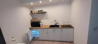 a kitchen with a sink and a counter top at ApartamentyM&K in Balice
