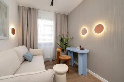 a living room with a white couch and a table at Klimatyzowany Apartament Blisko Parku w Krakowie z 3 Sypialniami, Wanną i Parkingiem by Renters Prestige in Kraków