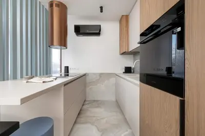a kitchen with a white counter and a sink at Klimatyzowany Apartament Blisko Parku w Krakowie z 3 Sypialniami, Wanną i Parkingiem by Renters Prestige in Kraków