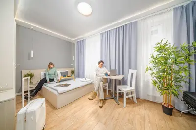 an outdoor patio with tables and chairs and plants at Apartamenty Platinia - komfortowe noclegi Kraków Stare Miasto in Kraków