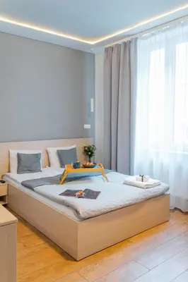 a hotel room with two beds and a living room at Apartamenty Platinia - komfortowe noclegi Kraków Stare Miasto in Kraków
