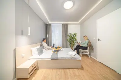 a bedroom with a bed with two towels on it at Apartamenty Platinia - komfortowe noclegi Kraków Stare Miasto in Kraków