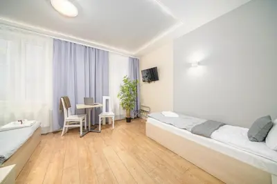 a bedroom with a bed with red rose petals on it at Apartamenty Platinia - komfortowe noclegi Kraków Stare Miasto in Kraków