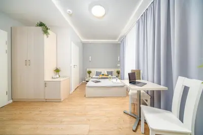 a waiting room with two chairs and a counter at Apartamenty Platinia - komfortowe noclegi Kraków Stare Miasto in Kraków