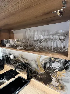 a row of wine glasses on a shelf at Kazimierz Art Apartment for 2 in Kraków