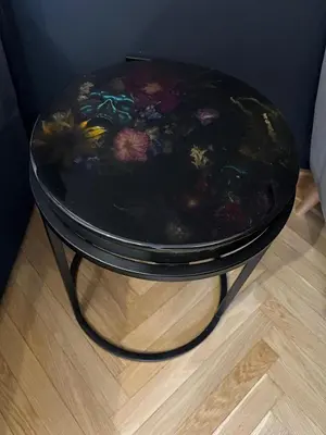 a black table with a flower pattern on it at Kazimierz Art Apartment for 2 in Kraków