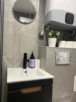 a bathroom with a sink and a mirror at Kazimierz Art Apartment for 2 in Kraków