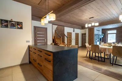 a kitchen and dining room with a table and chairs at Domek nad Potokiem 2 in Nowy Targ