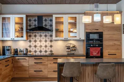 a kitchen with wooden cabinets and a counter top at Domek nad Potokiem 2 in Nowy Targ