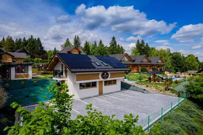 a house with solar panels on the roof at Zdrojowy Gościniec - Apartament Premium na wyłącznosć in Rabka