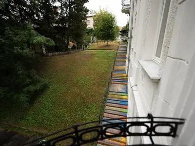 a group of colorful steps on the side of a building at Luksusowy Apartament na Podgórzu - by Upstairs in Kraków