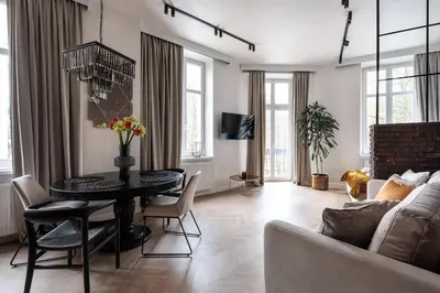 a living room with a table and a couch at Luksusowy Apartament na Podgórzu - by Upstairs in Kraków