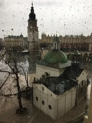 a building with a clock tower in a city at Queen's apartment from the 14th century - 130 m2 AC in Kraków