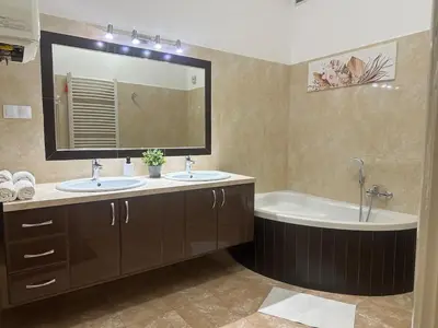 a bathroom with two sinks and a tub and a mirror at Queen's apartment from the 14th century - 130 m2 AC in Kraków