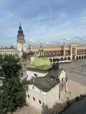 a building with a green roof and a large building at Queen's apartment from the 14th century - 130 m2 AC in Kraków