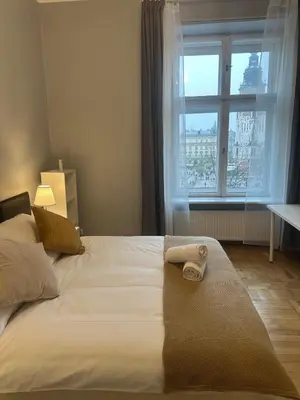 a bed with a towel on it with a window at Queen's apartment from the 14th century - 130 m2 AC in Kraków