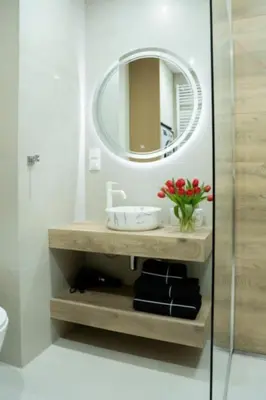 a bathroom with a sink and a mirror at Apartament Glamour Garden Kraków in Kraków