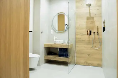 a bathroom with a toilet and a mirror at Apartament Glamour Garden Kraków in Kraków