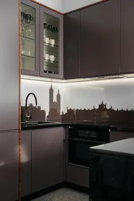 a kitchen with black cabinets and a sink at Native Apartments Lenartowicza 17 in Kraków
