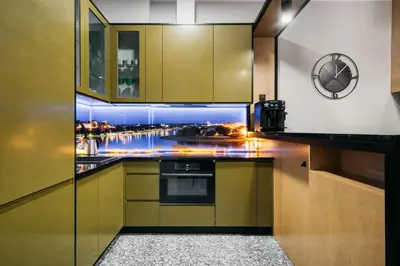 a kitchen with yellow cabinets and a view of a city at Native Apartments Lenartowicza 17 in Kraków