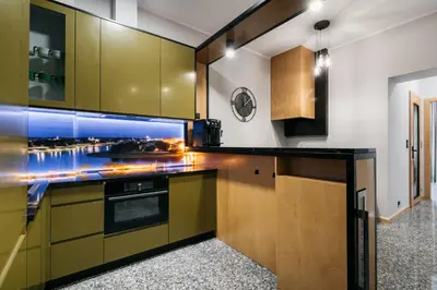 a kitchen with green cabinets and a counter top at Native Apartments Lenartowicza 17 in Kraków