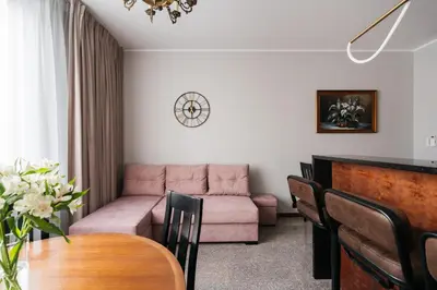 a living room with a couch and a table at Native Apartments Lenartowicza 17 in Kraków