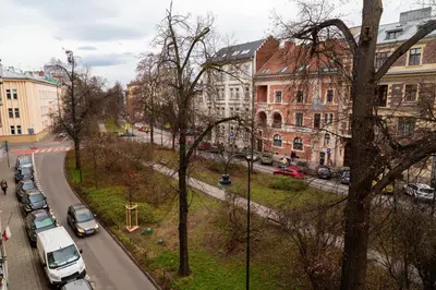 a city street with cars parked on the side of the road at Househost Apartment Retoryka in Kraków