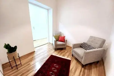 a living room with two chairs and a window at Old Town Apt - 5 bedrooms Sołtyka S2 in Kraków