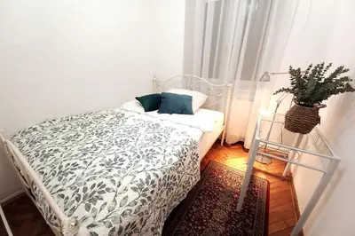 a bedroom with a bed and a potted plant at Old Town Apt - 5 bedrooms Sołtyka S2 in Kraków