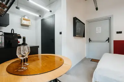 a table with a wine glass on it in a room at Golden Merchant Main Square in Kraków