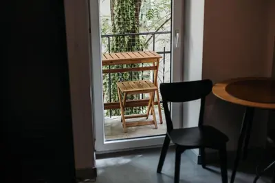 a chair and a table on a balcony at Golden Merchant Main Square in Kraków