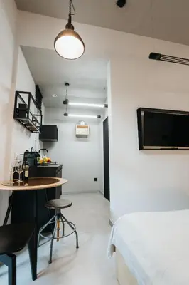 a room with a bed and a table and chairs at Golden Merchant Main Square in Kraków