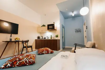 a small room with a bed and a kitchen at Golden Merchant Main Square in Kraków