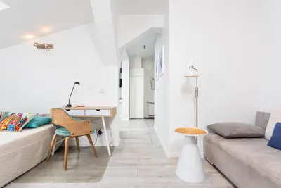a living room with a couch and a desk at LION apartments - Elegance in Kraków