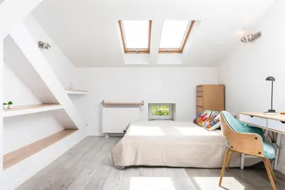 a bedroom with a bed and a desk at LION apartments - Elegance in Kraków
