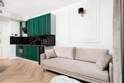 a living room with green cabinets and a couch at City of the Kings - Riverside K22 m44 in Kraków