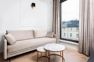 a living room with a couch and a window at City of the Kings - Riverside K22 m44 in Kraków