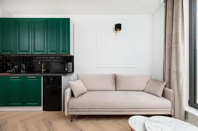 a living room with green cabinets and a couch at City of the Kings - Riverside K22 m44 in Kraków