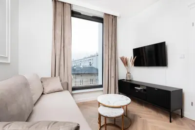 a living room with a couch and a large window at City of the Kings - Riverside K22 m44 in Kraków
