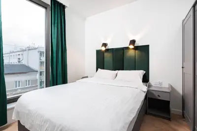 a bedroom with a large bed and a large window at City of the Kings - Riverside K22 m44 in Kraków