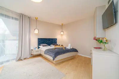 a living room with a couch and a kitchen at Comfy Apartment Old Town - by Hosty in Kraków