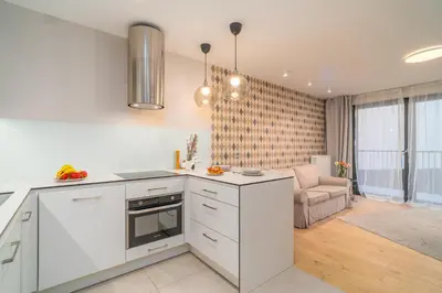 a bedroom with a bed and a table and a desk at Comfy Apartment Old Town - by Hosty in Kraków