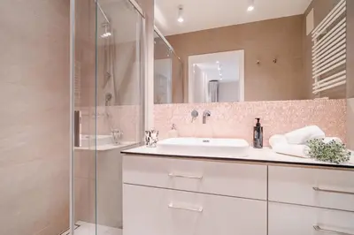 a bathroom with a sink and a shower and a mirror at Comfy Apartment Old Town - by Hosty in Kraków