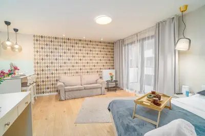 a small bedroom with a bed and a desk at Comfy Apartment Old Town - by Hosty in Kraków