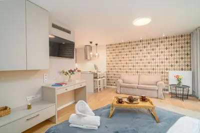 a bedroom with a bed with two towels on it at Comfy Apartment Old Town - by Hosty in Kraków