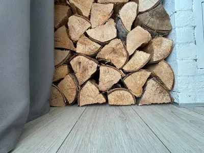a pile of wood on the side of a wall at Zaczarowane Wzgórze - Domek w Beskidach in Czaniec
