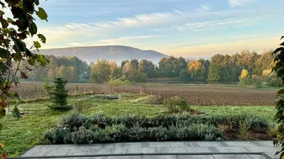 a garden with a view of a field at Zaczarowane Wzgórze - Domek w Beskidach in Czaniec
