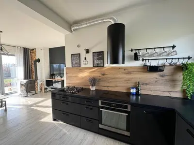 a kitchen with a black counter and a stove at Zaczarowane Wzgórze - Domek w Beskidach in Czaniec