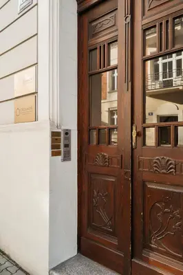 a wooden door in front of a building at Native Apartments Kraszewskiego 26 in Kraków