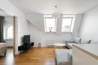 a living room with a couch and a tv at Native Apartments Kraszewskiego 26 in Kraków